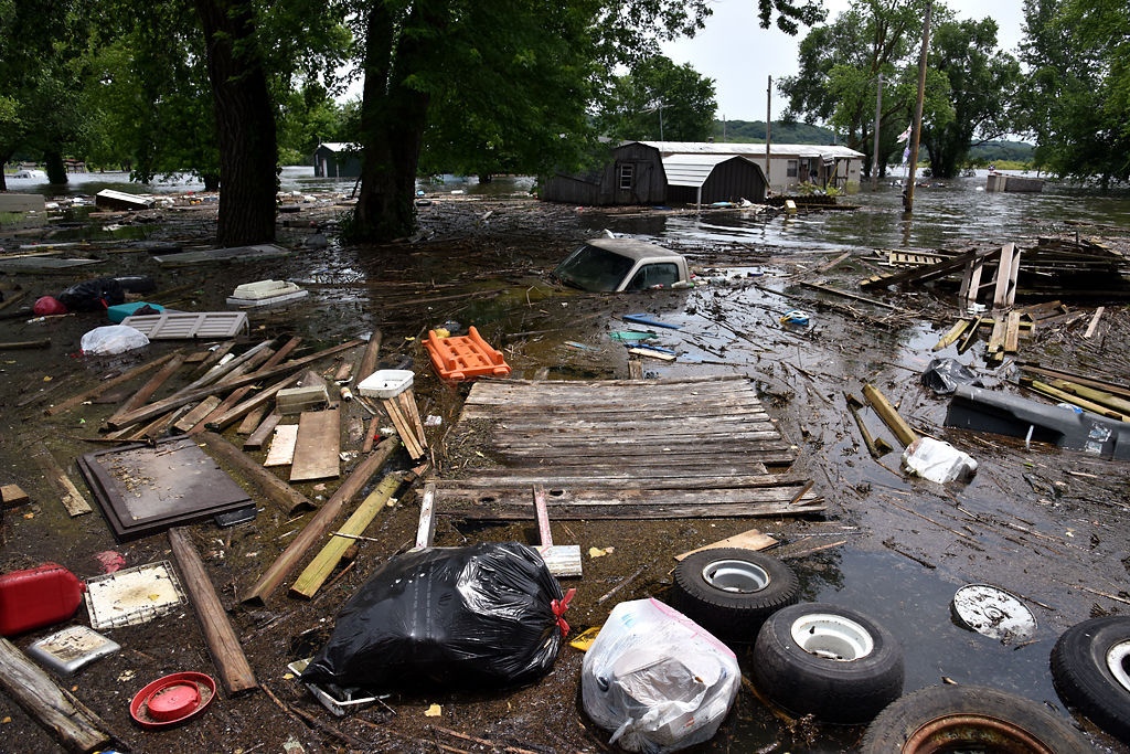 Debris from houses float toward the shore